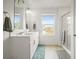 Bathroom featuring a double vanity, a window, and a glass door shower at 562 Twilight Ct, Fort Lupton, CO 80621