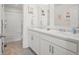 Bright bathroom with double sink vanity, modern fixtures and tub with shower at 562 Twilight Ct, Fort Lupton, CO 80621