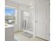 Clean bathroom featuring a glass door shower and a bright window at 562 Twilight Ct, Fort Lupton, CO 80621