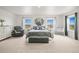 Spacious bedroom featuring carpet flooring, a lounge chair, a crib, and windows offering natural light at 562 Twilight Ct, Fort Lupton, CO 80621