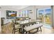 Dining area featuring hardwood floors and backyard access connected to living room at 562 Twilight Ct, Fort Lupton, CO 80621