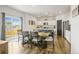 Dining area adjacent to the kitchen, featuring hardwood floors and access to the backyard at 562 Twilight Ct, Fort Lupton, CO 80621