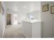 Bright upstairs hallway; view to bedrooms; carpeted in neutral shades at 562 Twilight Ct, Fort Lupton, CO 80621