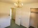 Spacious bedroom with carpeted flooring, a classic chandelier, and closet at 5922 S Otis Ct, Littleton, CO 80123