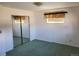 Cozy bedroom includes a mirrored closet and window with decorative valance at 5922 S Otis Ct, Littleton, CO 80123