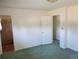 Clean bedroom featuring carpeted floors, neutral walls, and closet at 5922 S Otis Ct, Littleton, CO 80123