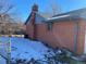 Brick house exterior with chimney and partial fenced yard at 5922 S Otis Ct, Littleton, CO 80123