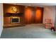 Living room with brick fireplace and wood paneled wall at 5922 S Otis Ct, Littleton, CO 80123