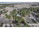 A bird's eye view of the green roofed house, encircled by mature trees at 34480 Pine Ridge Cir, Elizabeth, CO 80107