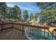 View of the property from the wooden back deck, showing mature trees and greenery at 34480 Pine Ridge Cir, Elizabeth, CO 80107