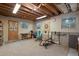 Finished basement featuring a workout area, recreation space, exposed beams, and natural light at 34480 Pine Ridge Cir, Elizabeth, CO 80107