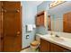 Cozy bathroom with blue walls, wood fixtures, and neutral finishes at 34480 Pine Ridge Cir, Elizabeth, CO 80107