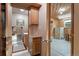 View of bathroom leading into paneled room with wood-covered walls and ceiling and metal filing cabinets at 34480 Pine Ridge Cir, Elizabeth, CO 80107