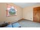 Neutral Bedroom with large window, and a blue chair with footstool at 34480 Pine Ridge Cir, Elizabeth, CO 80107