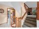 An inviting foyer with stairs leading up and white tiles on the floor at 34480 Pine Ridge Cir, Elizabeth, CO 80107