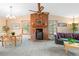 Cozy Living Room with a brick fireplace, wood accents, and large windows at 34480 Pine Ridge Cir, Elizabeth, CO 80107