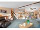 Cozy living room with vaulted ceiling, carpet, and a view into the kitchen at 34480 Pine Ridge Cir, Elizabeth, CO 80107