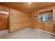 Wood-paneled room featuring a window with views of the surrounding trees and ample space for furniture at 34480 Pine Ridge Cir, Elizabeth, CO 80107