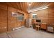 Cozy wood-paneled office space featuring a computer desk setup and natural light from two windows at 34480 Pine Ridge Cir, Elizabeth, CO 80107