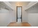 Walk-in closet with wooden floors, and shelves with access to the bathroom at 700 N Washington St, Denver, CO 80203