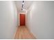 Hallway featuring a red door, closet and new flooring at 700 N Washington St, Denver, CO 80203