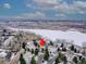 Winter aerial view of a neighborhood with an arrow pointing to the property at 8312 S Peninsula Dr, Littleton, CO 80120