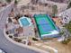 Aerial view of a community pool and tennis court with snow covering the ground at 8312 S Peninsula Dr, Littleton, CO 80120
