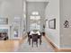 Bright dining area featuring a chandelier, tall windows, and hardwood floors at 8312 S Peninsula Dr, Littleton, CO 80120