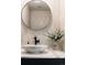 Elegant powder room with a marble sink and a large round mirror at 1133 14Th St # 2720, Denver, CO 80202