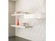 White geometric backsplash with floating shelves in kitchen at 1133 14Th St # 2720, Denver, CO 80202