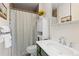 The bathroom features a shower with a patterned curtain, a toilet, and a vanity sink at 1200 Butterfield Ln, Castle Rock, CO 80104