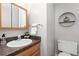 Well-lit bathroom with a wooden vanity, modern fixtures, and a clean, neutral color scheme at 1200 Butterfield Ln, Castle Rock, CO 80104