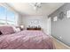 This bedroom features a window with curtains, wall decor, and a dresser with books at 1200 Butterfield Ln, Castle Rock, CO 80104