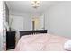 This Bedroom features floral curtains, a black dresser, and a view to an open door at 1200 Butterfield Ln, Castle Rock, CO 80104