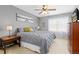 This bedroom features gray walls, lamps, a window, and a dresser with a television at 1200 Butterfield Ln, Castle Rock, CO 80104