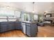 Open-concept kitchen with granite countertops, stainless steel appliances, and hardwood floors at 1200 Butterfield Ln, Castle Rock, CO 80104