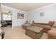 Spacious living room with a large sectional sofa, neutral carpeting, and adjacent dining area at 1200 Butterfield Ln, Castle Rock, CO 80104