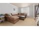 Cozy living room with a comfortable sectional sofa, neutral carpeting, and plenty of natural light at 1200 Butterfield Ln, Castle Rock, CO 80104