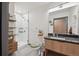 Modern bathroom with a glass-enclosed shower, vanity, and shelving at 603 Inca St # 330, Denver, CO 80204