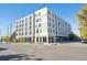 Corner view of an apartment building with a combination of gray and white brick facade and large windows at 603 Inca St # 330, Denver, CO 80204