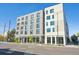 Modern apartment building with a combination of gray and white brick facade, large windows, and street view at 603 Inca St # 330, Denver, CO 80204