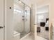 Clean and modern bathroom with a glass shower, a marble seat, and a view of the bedroom at 6172 N Liverpool St, Aurora, CO 80019