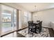 Well-lit dining area with modern chandelier, patio door access and seating for six at 6172 N Liverpool St, Aurora, CO 80019