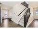 A bright entryway with hard wood floors and a carpeted staircase leading to the second floor at 6172 N Liverpool St, Aurora, CO 80019