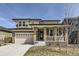 Two-story home boasting a two-car garage, covered porch with brick columns, and low maintenance landscaping at 6172 N Liverpool St, Aurora, CO 80019