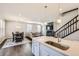 Modern kitchen flows into the dining and living areas and features a large island with white countertops at 6172 N Liverpool St, Aurora, CO 80019