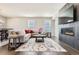 A spacious living room features a cozy fireplace, plush sofa, and elegant decor at 6172 N Liverpool St, Aurora, CO 80019