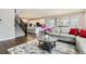 Open floor plan with a combined living room, kitchen, and dining area with dark wood floors at 6172 N Liverpool St, Aurora, CO 80019