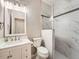 Bathroom featuring a marble-style shower, modern lighting, and vanity with ample storage at 7922 S Algonquian Way, Aurora, CO 80016
