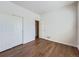 Bright bedroom features wood floors and closet with sliding doors at 7922 S Algonquian Way, Aurora, CO 80016